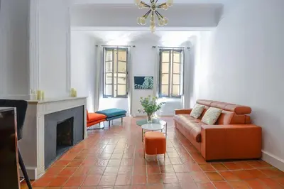 a living room with a couch and a fireplace at Élégant Appartement Standing à 3min du Cours Mirabeau in Aix-en-Provence