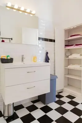 a bathroom with a white sink and a black and white floor at Appartement vue superbe 70m2 2Balcons 2Chambres VRAI CLIMATISATION in Aix-en-Provence