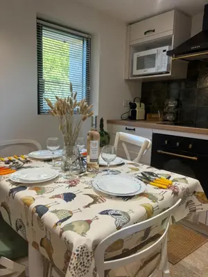 a kitchen with a table with plates on it at Charmante maison Provençale avec grand jardin in LʼIsle-sur-la-Sorgue