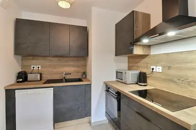 a kitchen with a sink and a counter top at Appartement moderne - Terrasse - Piscine - Parking in Ventabren