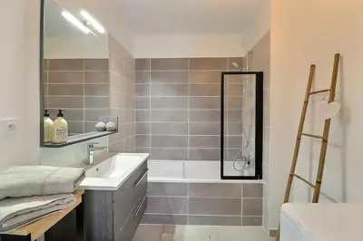 a bathroom with a tub and a sink and a shower at Appartement moderne - Terrasse - Piscine - Parking in Ventabren