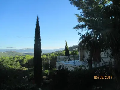 a view from the garden of a villa with trees at Villa Boulou in Rognes