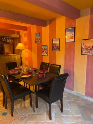 a dining room with a table and chairs at Charmant duplex bucolique, piscine, en Provence in Le Beaucet