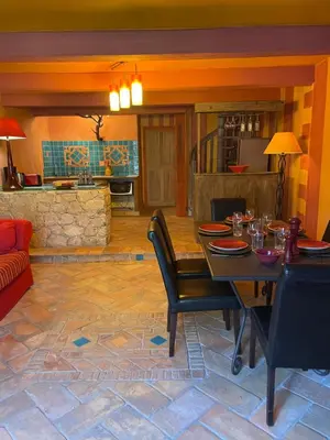 a living room with a table and a couch at Charmant duplex bucolique, piscine, en Provence in Le Beaucet