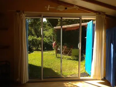 a sliding glass door with a view of a yard at La restanque in La Tour-dʼAigues