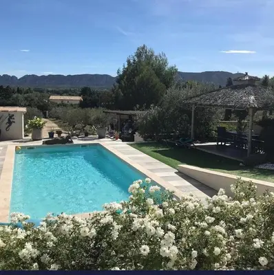 a large swimming pool in a yard with a garden at Villa aloha in Saint-Rémy-de-Provence