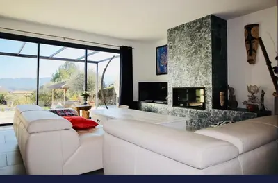 a living room with two white couches and a fireplace at Villa aloha in Saint-Rémy-de-Provence