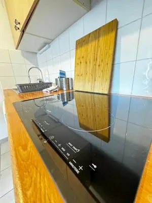 a laptop sitting on a counter in a kitchen at Jungle Cosy - Gare - Bus - Parking gratuit - WIFI in Avignon