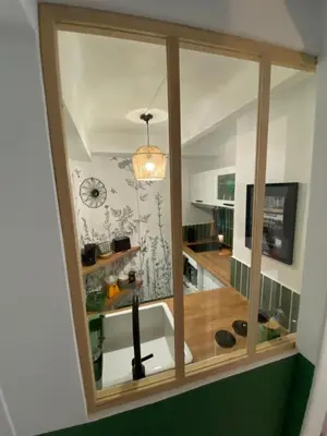 a kitchen with a sink and a clock on the wall at Le Petit Vendôme avec terrasse in Aix-en-Provence