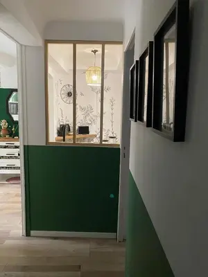 a hallway with a green door in a house at Le Petit Vendôme avec terrasse in Aix-en-Provence