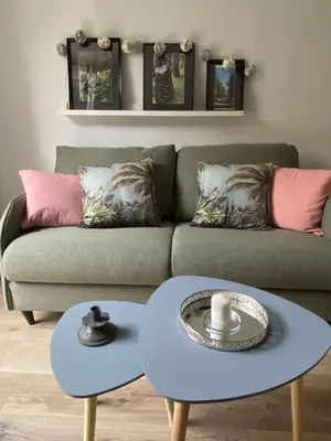 a living room with a couch and two tables at Le Petit Vendôme avec terrasse in Aix-en-Provence