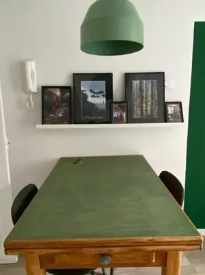 a green table with chairs and a green lamp at Le Petit Vendôme avec terrasse in Aix-en-Provence