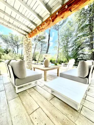 a patio with two couches and a table at Zen et Chic, juste à coté de la Bastide de Marie in Ménerbes