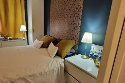 a bedroom with a bed and a table with a lamp at Le Ciel Bleu Clim Wifi Garage in Aix-en-Provence