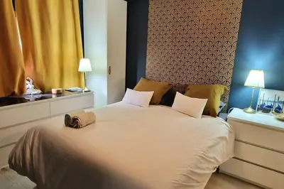 a bedroom with a large white bed with two pillows at Le Ciel Bleu Clim Wifi Garage in Aix-en-Provence