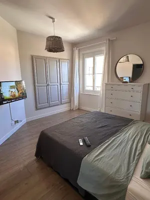 a bedroom with a bed and a dresser and a mirror at Appartement clim & piscine sur Golf in Pont-Royal en Provence