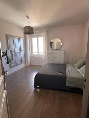a bedroom with a bed and a dresser and a mirror at Appartement clim & piscine sur Golf in Pont-Royal en Provence