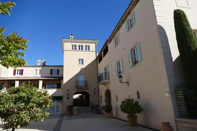 a view of a building with a tower at Appartement clim & piscine sur Golf in Pont-Royal en Provence
