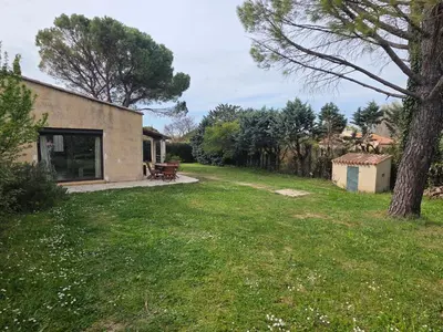 a house with a yard with a bench and a tree at Maison à Aix-en-Provence avec grand jardin in Aix-en-Provence
