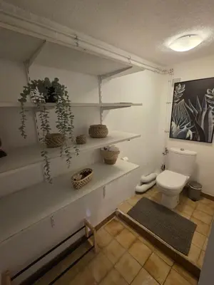 a bathroom with white shelves and a toilet at Maison à Aix-en-Provence avec grand jardin in Aix-en-Provence