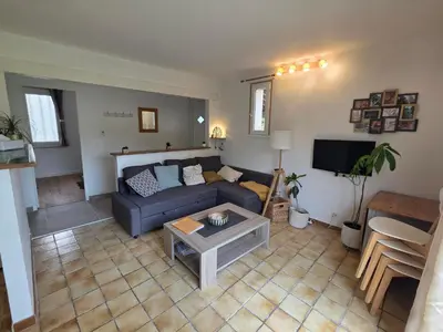 a living room with a couch and a table at Maison à Aix-en-Provence avec grand jardin in Aix-en-Provence