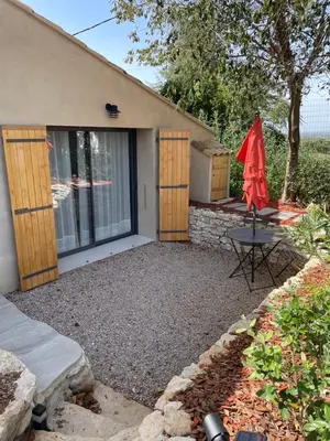 a house with a patio and a table in front of it at STUDIO campagne Les Clapiers AIX EN PROVENCE in Aix-en-Provence