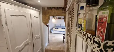 a hallway with a room with a bed in the background at Appartement centre historique - climatisé avec extérieur au calme in Aix-en-Provence