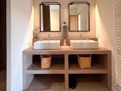 a bathroom with two sinks and two mirrors at La Calade de Goult in Goult