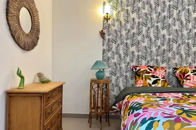 a bedroom with a bed and a dresser and a mirror at Comme Chez Mémé house with terrace in the center in Fontaine-de-Vaucluse