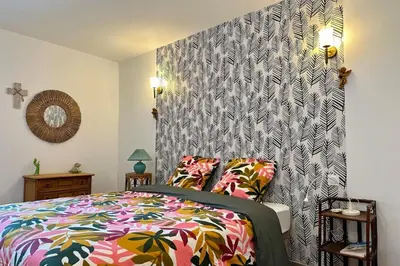 a pink teddy bear is sitting on a bed at Comme Chez Mémé house with terrace in the center in Fontaine-de-Vaucluse