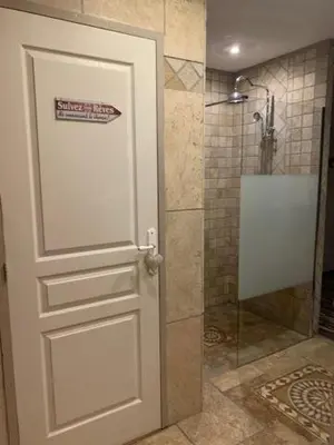 a white door with a sign on it in a bathroom at Un havre de paix au coeur de la Provence in Châteaurenard