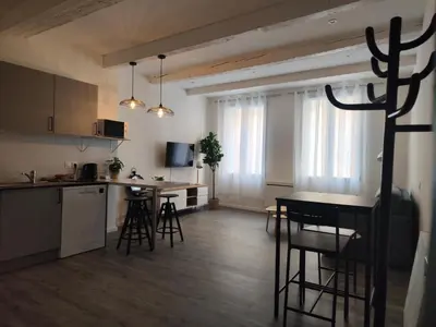 a kitchen and living room with a table and chairs at Bon Pasteur in Aix-en-Provence