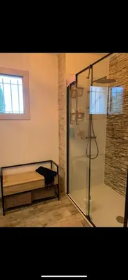 a bathroom with a shower and a bench in a room at Chambre d hôtes chez l habitant in Velaux