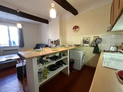 a kitchen with a counter with pots and pans at Chez Florence - Appartement T2 d au cœur du centre ville historique - Proche Cardeurs et Mairie in Aix-en-Provence