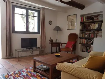 a living room with a couch and a table and a tv at Les Gites de Catherine in Gargas
