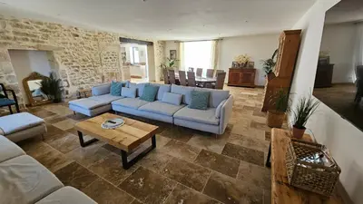 a living room with a couch and a table at Mas mes Aïeux in Saint-Rémy-de-Provence