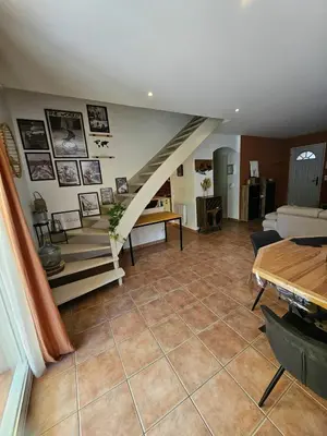 a kitchen with white cabinets and a tile floor at Maison des Fenaisons in Entraigues-sur-la-Sorgue