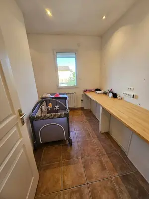 a living room with a staircase and a table at Maison des Fenaisons in Entraigues-sur-la-Sorgue