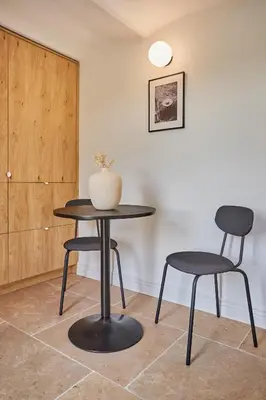 a table and two chairs and a vase on a table at TERRE UGO - Villa & Suites au cœur des lavandes de Provence in Aix-en-Provence