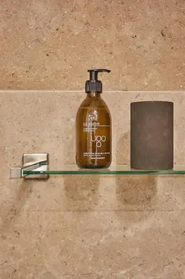 a soap bottle sitting on a shelf in a bathroom at TERRE UGO - Villa & Suites au cœur des lavandes de Provence in Aix-en-Provence