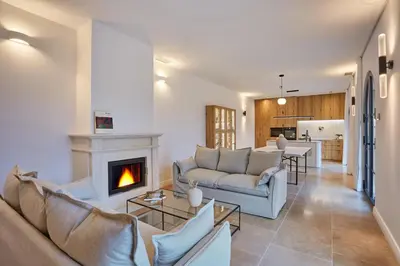 a living room with two couches and a fireplace at TERRE UGO - Villa & Suites au cœur des lavandes de Provence in Aix-en-Provence