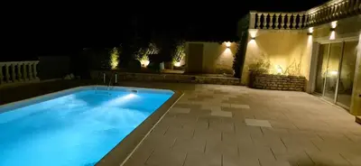 a swimming pool in a yard at night at Restanques de la Tour in La Tour-dʼAigues