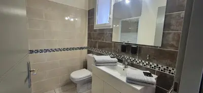 a bathroom with a toilet and a sink and a mirror at Restanques de la Tour in La Tour-dʼAigues