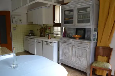 a kitchen with white cabinets and a white counter top at Une Chambre aux Gabions in Cavaillon