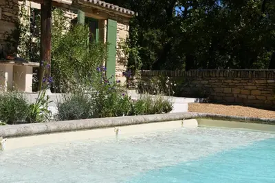 a swimming pool in front of a house at La Piscine dans la Foret in Gordes