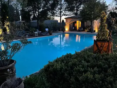 a large swimming pool with blue water in a yard at Gite au coeur de la Provence & SPA in Saint-Cannat