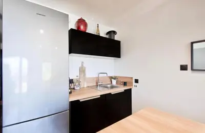 a kitchen with a sink and a refrigerator at appartement pont royal in Mallemort