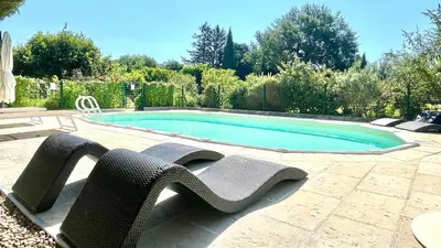 a swimming pool with two lawn chairs and a swimming pool at Rendez-vous en Provence -10 personnes- duo de gîtes- piscine privée - clim in Cheval-Blanc
