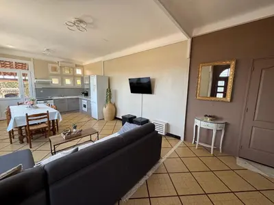 a living room with a couch and a table at Domaine Les feuilles de Chêne in Carpentras
