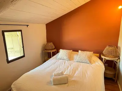 a bedroom with a white bed with two chairs at Le Scandinave in Aix-en-Provence